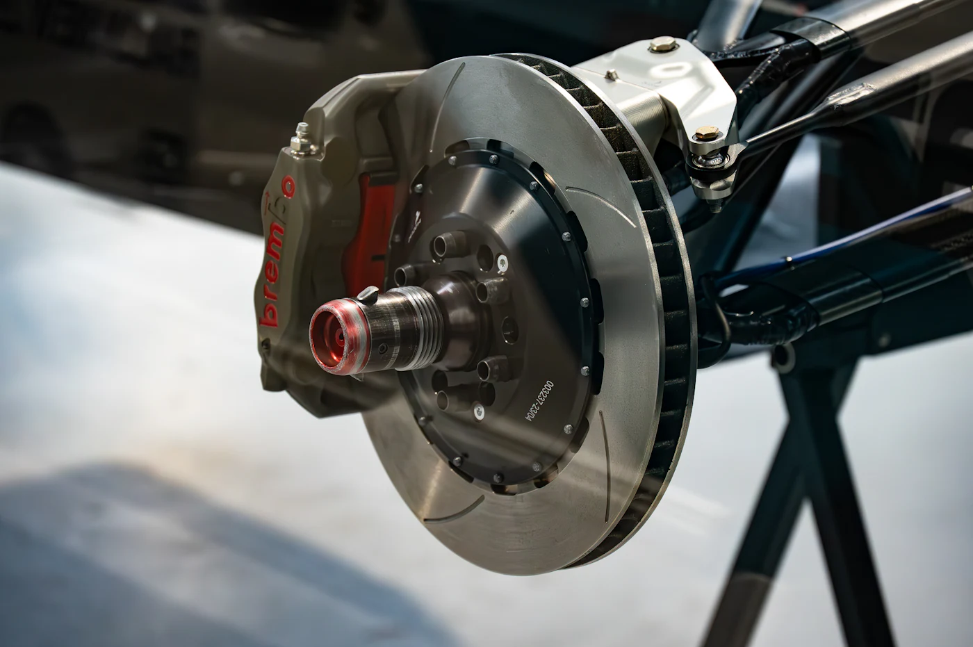 Close-up of a brake disc and caliper on a car in the workshop